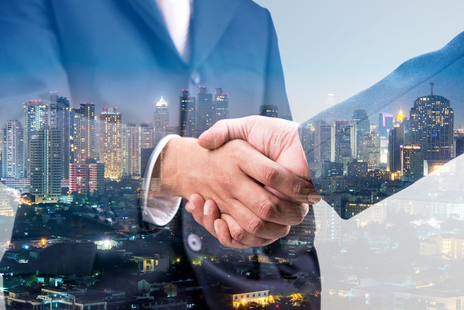 A business handshake over a city skyline &ndash; Tanglin's long-term IT partnerships